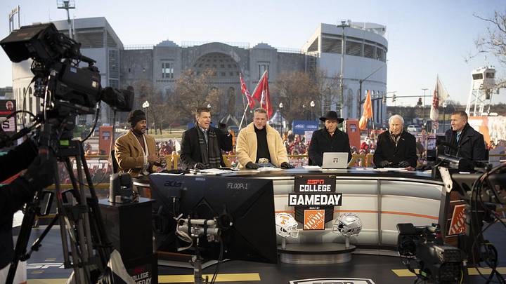 ESPN cast, from left, Desmond Howard, Rece Davis, Pat McAfee, Nick Saban, Lee Corso and Kirk Herbstreit sit on the set of College GameDay prior to the College Football Playoff first round game between the Ohio State Buckeyes and Tennessee Volunteers in Columbus on Dec. 21, 2024.