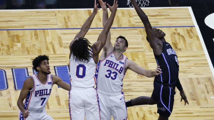 Dec 31, 2020; Orlando, Florida, USA; Orlando Magic guard Karim Mane (4) fights for the rebound with Philadelphia 76ers guards Tyrese Maxey (0) and Dakota Mathias (33) and Isaiah Joe (7) during the fourth quarter at Amway Center. Mandatory Credit: Reinhold Matay-USA TODAY Sports