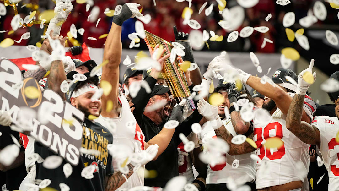Ohio State Buckeyes head coach Ryan Day and players celebrate with the trophy following the 34-23 win over the Notre Dame Fighting Irish to win the College Football Playoff National Championship at Mercedes-Benz Stadium in Atlanta on Jan. 22, 2025.