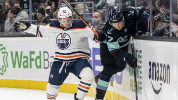 Dec 18, 2021; Seattle, Washington, USA; Edmonton Oilers center Seth Griffith (23) and Seattle Kraken center Morgan Geekie (67) battle for the puck during the second period at Climate Pledge Arena. Mandatory Credit: Stephen Brashear-USA TODAY Sports