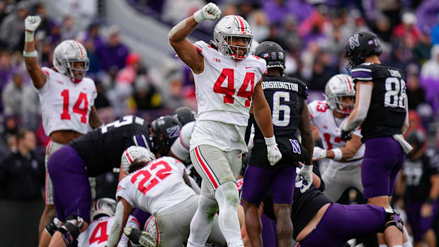 Colts defensive end J.T. Tuimoloau (silver helmet) celebrates after making a big play on defense.