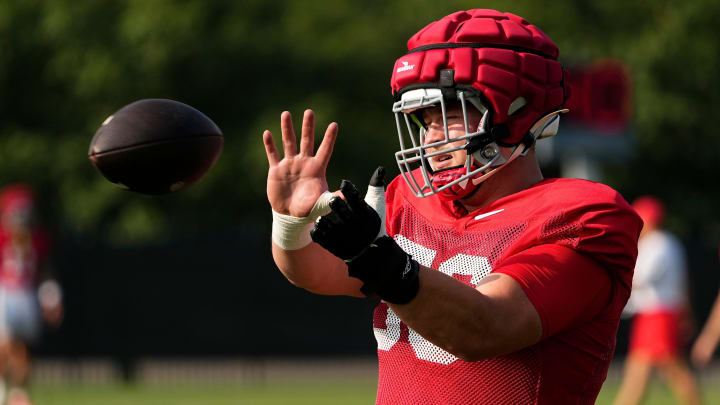 Aug 8, 2024; Columbus, Ohio, USA; Ohio State Buckeyes offensive lineman Seth McLaughlin (56) catches a ball during football practice at the Woody Hayes Athletic Complex.