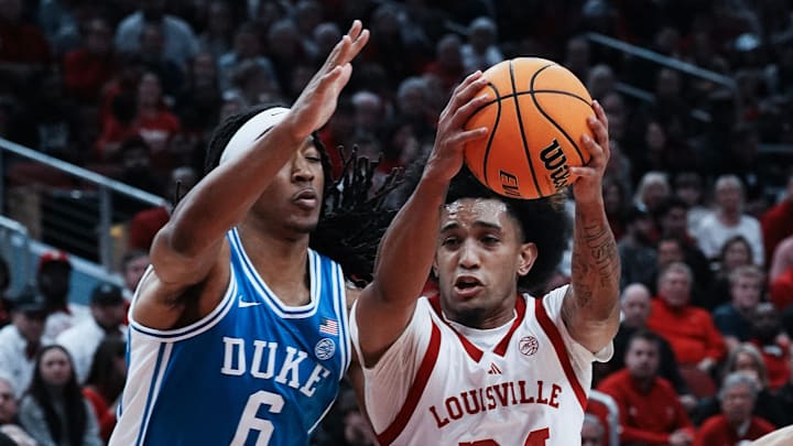 Louisville's Chucky Hepburn (24) drives against Duke basketball center Maliq Brown (6) during their game at the KFC Yum! Center in Louisville, Ky. on Dec. 8, 2024.