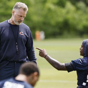 Matt Eberflus listens to a point being made by Nsimba Webster at Bears minicamp. Eberflus is a coach of the year favorite but also said to be one of the hot seat candidates.