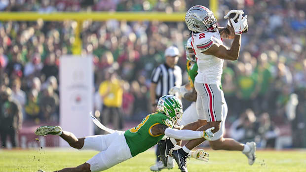 Ohio State Buckeyes wide receiver Emeka Egbuka catches a pass over Oregon Ducks defensive back Nikko Reed during Rose Bowl.