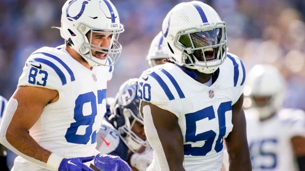 Indianapolis Colts linebacker Segun Olubi (all-white uniform) celebrates after a big play with his teammates. 