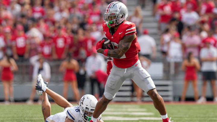 Aug 31, 2024; Columbus, OH, USA; Ohio State Buckeyes wide receiver Emeka Egbuka (2) eludes Akron Zips cornerback Joey Hunter (6) after making a catch during the first half of the NCAA football game at Ohio Stadium.