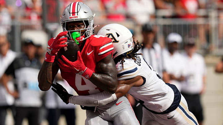 Aug 31, 2024; Columbus, OH, USA; Ohio State Buckeyes wide receiver Jeremiah Smith (4) catches his second touchdown pass of the first half in front of Akron Zips cornerback Devonte Golden-Nelson (3) during the NCAA football game at Ohio Stadium.