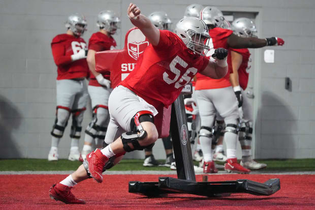 Offensive lineman runs past sled during practice.