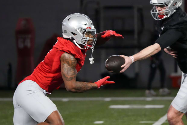 Quarterback hands off to running back.