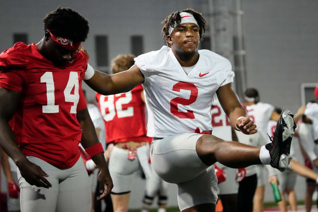 Safety and wide receiver stretch together.