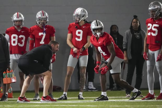 Wide receiver lines up to run route in practice.