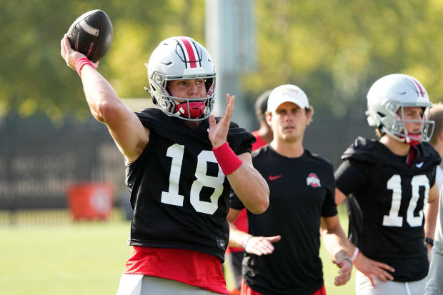 Quarterback throws during practice.