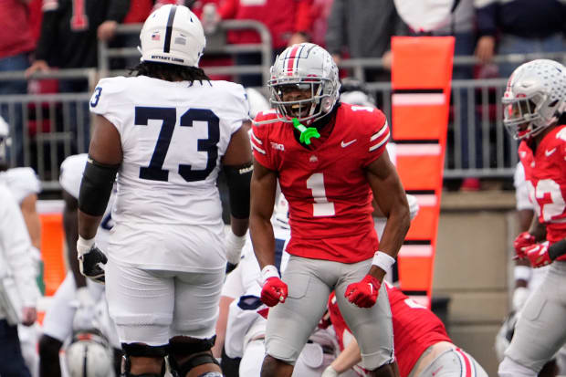 Defensive back celebrates in front of opponent.