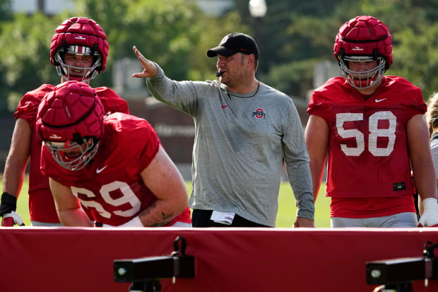 Coach blows whistle during drill.