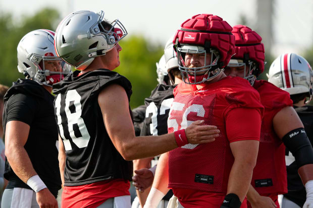 Center and quarterback speak during practice.