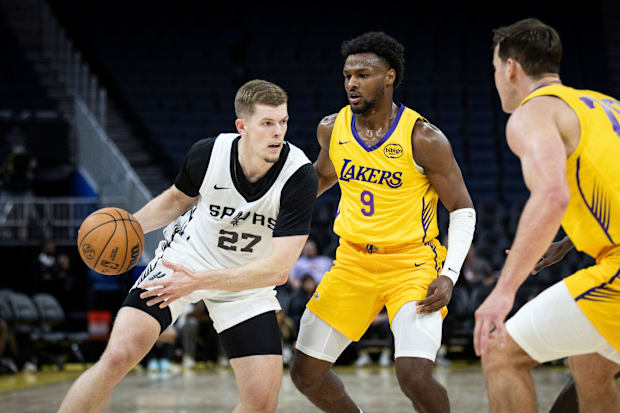 San Antonio Spurs two-way forward Riley Minix (27) drives to the rim against Los Angeles Lakers guard Bronny James (9) during
