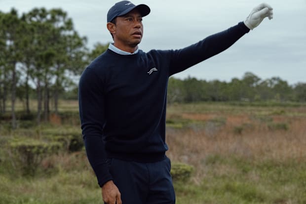 Tiger Woods plays golf in Sun Day Red apparel.