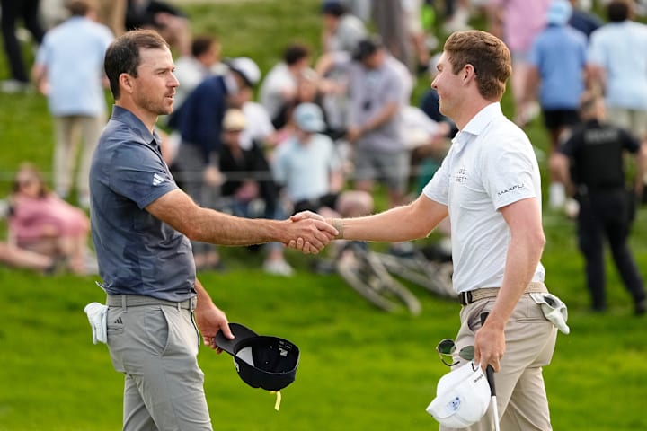 Ben Griffin and Nick Taylor shake hands after finishing Round 3 of the Memorial Tournament at Muirfield Village Golf Club.
