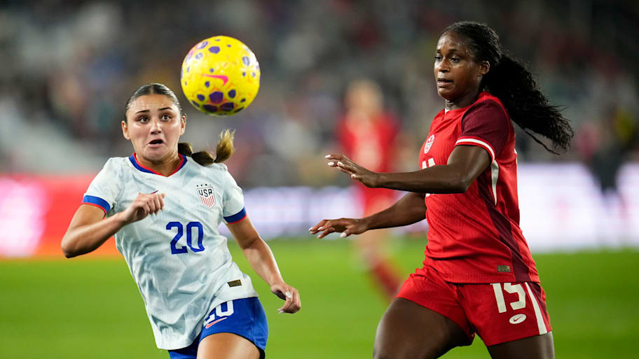 United States defender Gisele Thompson tracks the ball in front of Canada forward Nichelle Prince 