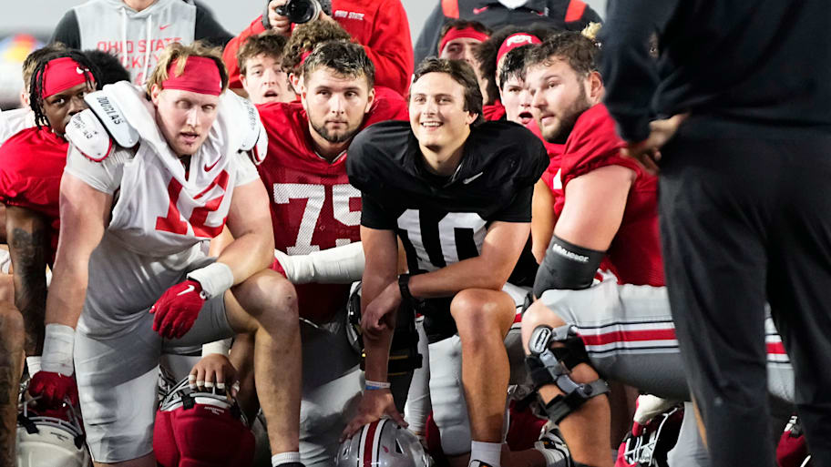 Ohio State quarterback Julian Sayin (10) laughs as the team huddles during a spring practice in April.