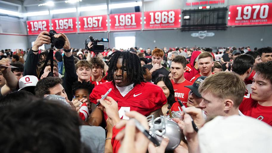 Ohio State wide receiver Jeremiah Smith takes photos and signs autographs following the Student Appreciation Day.