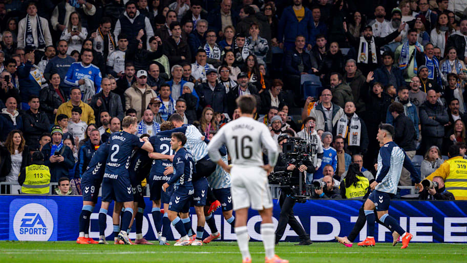 Gonzalo García looks on at celebrating Celta Vigo players.