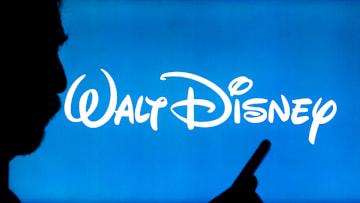 In this photo illustration, The Walt Disney Company logo...