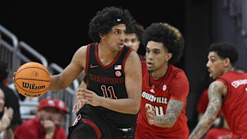 Mar 8, 2025; Louisville, Kentucky, USA;  Stanford Cardinal guard Ryan Agarwal (11) dribbles against Louisville Cardinals guard Chucky Hepburn (24) during the second half at KFC Yum! Center. Louisville defeated Stanford 68-48. Mandatory Credit: Jamie Rhodes-Imagn Images