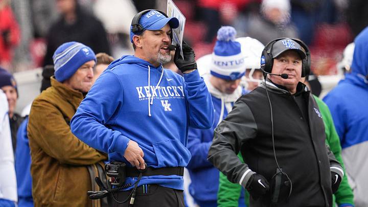 Kentucky defensive coordinator Brad White and head football coach Mark Stoops on the sidelines as UK athletic director Mitch Barnhart stands behind them at left during the loss against UofL Saturday, November 29, 2025 in Louisville, Kentucky at L&N Federal Credit Union Stadium. The Cards shut out the Cats 41-0.