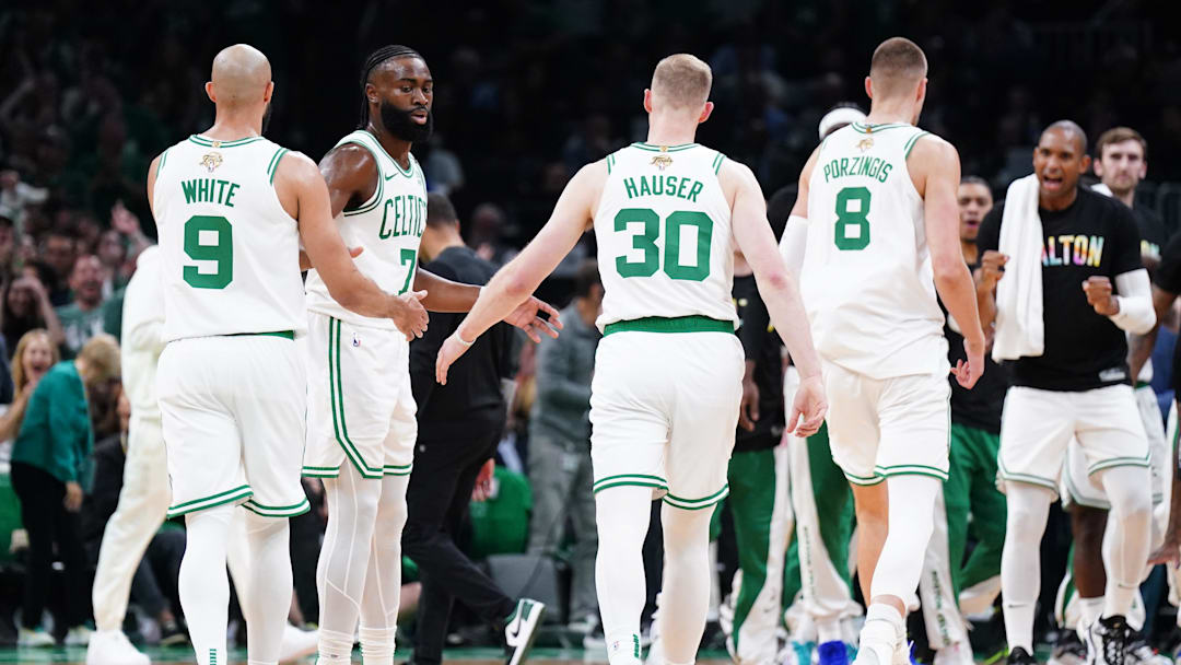 Jun 6, 2024; Boston, Massachusetts, USA; Boston Celtics forward Sam Hauser (30) and guard Jaylen Brown (7) react in the first quarter against the Dallas Mavericks during game one of the 2024 NBA Finals at TD Garden. Mandatory Credit: David Butler II-Imagn Images