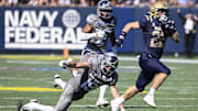 Navy Midshipmen wide receiver Eli Heidenreich, a Mt. Lebanon graduate, runs by a diving Air Force Falcons defensive back Houston Hendrix (19) for a first half touchdown at Navy-Marine Corps Memorial Stadium. 