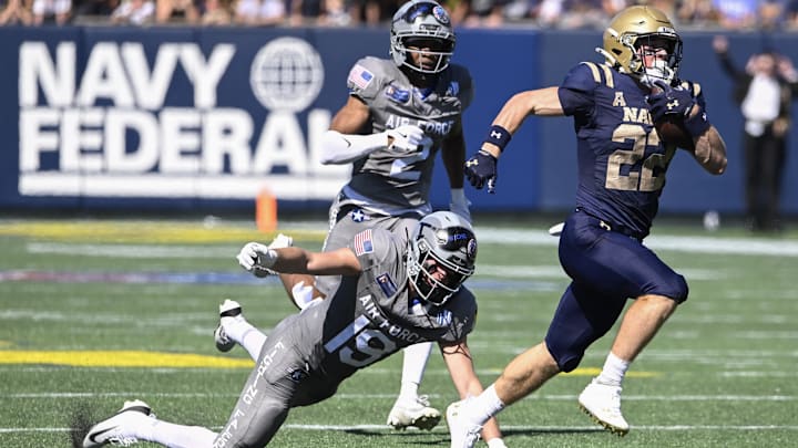 Navy Midshipmen wide receiver Eli Heidenreich, a Mt. Lebanon graduate, runs by a diving Air Force Falcons defensive back Houston Hendrix (19) for a first half touchdown at Navy-Marine Corps Memorial Stadium. Navy Midshipmen wide receiver Eli Heidenreich, a Mt. Lebanon graduate, runs by a diving Air Force Falcons defensive back Houston Hendrix (19) for a first half touchdown at Navy-Marine Corps Memorial Stadium.