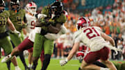 Oct 25, 2025; Miami Gardens, Florida, USA; Miami Hurricanes running back Mark Fletcher Jr. (4) carries the football against Stanford Cardinal safety Mitch Leigber (32) and safety Scotty Edwards (21) during the third quarter at Hard Rock Stadium. Mandatory Credit: Sam Navarro-Imagn Images