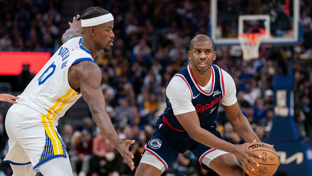 Oct 28, 2025; San Francisco, California, USA; LA Clippers guard Chris Paul prepares to pass the basketball against Golden State Warriors forward Jimmy Butler III (10) during the third quarter at Chase Center. Mandatory Credit: Neville E. Guard-Imagn Images