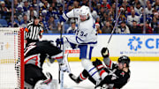Dec 20, 2024; Buffalo, New York, USA;  Buffalo Sabres goaltender James Reimer (47) makes a save on Toronto Maple Leafs center Auston Matthews (34) as Buffalo Sabres defenseman Bowen Byram (4) falls down trying to defend during the third period at KeyBank Center. Mandatory Credit: Timothy T. Ludwig-Imagn Images