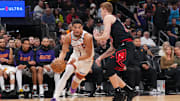 Mar 19, 2025; Phoenix, Arizona, USA; Phoenix Suns guard Devin Booker (1) dribbles against Chicago Bulls guard Kevin Huerter (13) during the second half at PHX Aena. Mandatory Credit: Joe Camporeale-Imagn Images