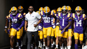 Jan 1, 2024; Tampa, FL, USA; LSU Tigers wide receivers coach Cortez Hankton, tight end Ka'Morreun Pimpton (88), and wide receiver Aaron Anderson (1) run onto the field before the game against the Wisconsin Badgers at Raymond James Stadium. Mandatory Credit: Matt Pendleton-USA TODAY Sports