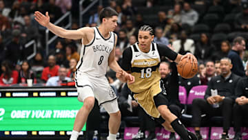 Nov 16, 2025; Washington, District of Columbia, USA;  Washington Wizards forward Kyshawn George (18) dribbles the ball past Brooklyn Nets guard Egor Demin (8) during the third quarter at Capital One Arena. Mandatory Credit: Rafael Suanes-Imagn Images