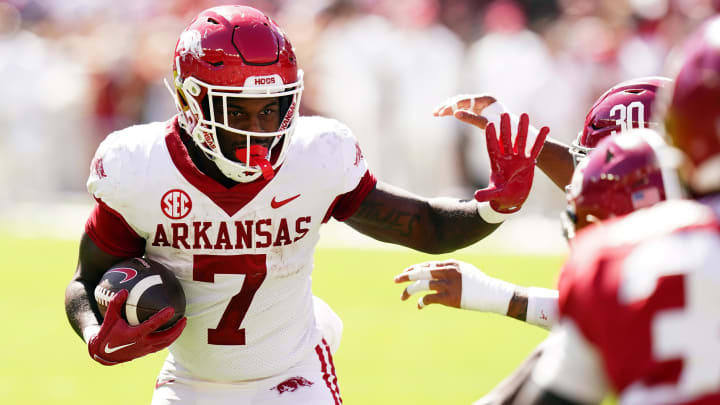 Arkansas Razorbacks running back Rashod Dubinion (7) carries the ball against the Alabama Crimson Tide during the fourth quarter at Bryant-Denny Stadium.