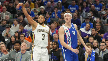 Dec 4, 2023; Sacramento, California, USA; New Orleans Pelicans guard CJ McCollum (3) follows through after a shot against Sacramento Kings guard Kevin Huerter (9) during the second quarter at Golden 1 Center. Mandatory Credit: Darren Yamashita-USA TODAY Sports