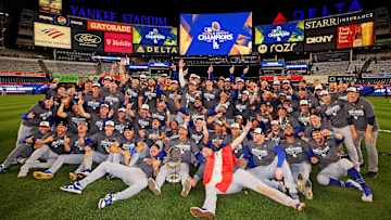 Oct 31, 2024; New York, New York, USA; The Los Angeles Dodgers pose for a picture with the Commissioner’s Trophy after beating the New York Yankees in game four to win the 2024 MLB World Series at Yankee Stadium. Mandatory Credit: Brad Penner-Imagn Images