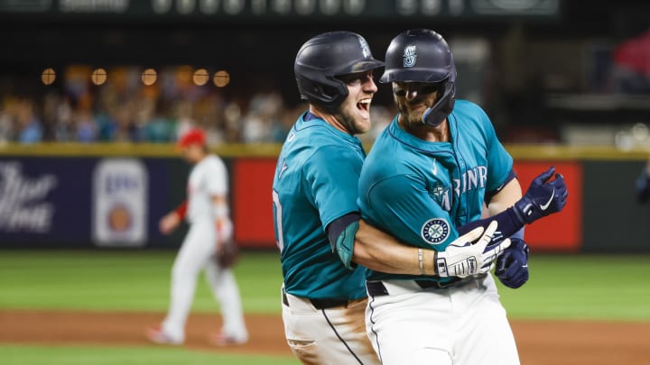 Seattle Mariners left fielder Luke Raley (20, left) hugs right fielder Mitch Haniger (17, right) following a walk-off walk by Haniger against the Philadelphia Phillies during the tenth inning at T-Mobile Park on Aug 3.