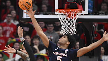 Jan 18, 2025; Louisville, Kentucky, USA;  Virginia Cavaliers forward Jacob Cofie (5) foul Louisville Cardinals guard Terrence Edwards Jr. (5) while blocking his shot during the first half at KFC Yum! Center. Mandatory Credit: Jamie Rhodes-Imagn Images
