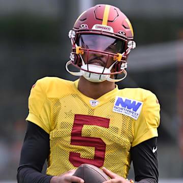Aug 6, 2025; Foxborough, MA, USA; Washington Commanders quarterback Jayden Daniels (5) with the ball at training camp at Gillette Stadium. Mandatory Credit: Eric Canha-Imagn Images