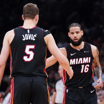 Apr 24, 2024; Boston, Massachusetts, USA; Miami Heat forward Caleb Martin (16) is congratulated after his three point basket by forward Nikola Jovic (5) against the Boston Celtics in the second quarter during game two of the first round for the 2024 NBA playoffs at TD Garden. Mandatory Credit: David Butler II-USA TODAY Sports