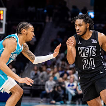 Mar 8, 2025; Charlotte, North Carolina, USA; Brooklyn Nets guard Cam Thomas (24) drives on Charlotte Hornets guard Nick Smith Jr. (8) during the second quarter at Spectrum Center. Mandatory Credit: Scott Kinser-Imagn Images