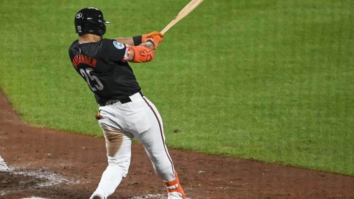 Aug 23, 2024; Baltimore, Maryland, USA; Baltimore Orioles right fielder Anthony Santander (25) swings through an eighth-inning grand slam against the Houston Astros at Oriole Park at Camden Yards.