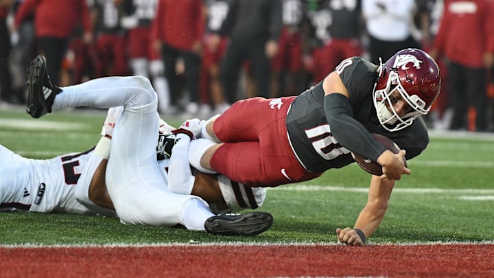 Sep 7, 2024; Pullman, Washington, USA; Washington State Cougars quarterback John Mateer (10) stretches for a touchdown against Texas Tech Red Raiders defensive back A.J. McCarty (1) in the first half at Gesa Field at Martin Stadium. Mandatory Credit: James Snook-Imagn Images