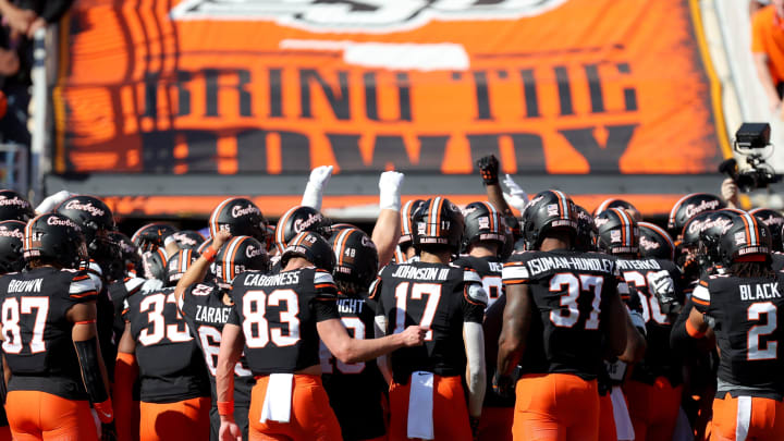 Oklahoma State huddles before a Bedlam college football game between the Oklahoma State University Cowboys (OSU) and the University of Oklahoma Sooners (OU) at Boone Pickens Stadium in Stillwater, Okla., Saturday, Nov. 4, 2023.